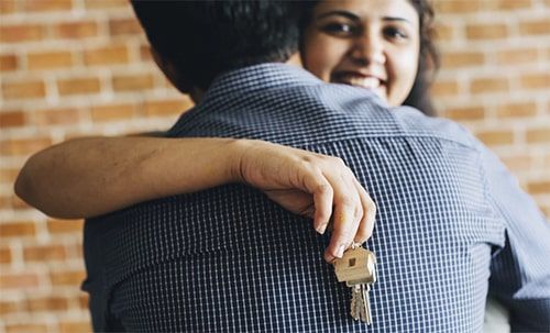 Agent handing house keys to a new tenant